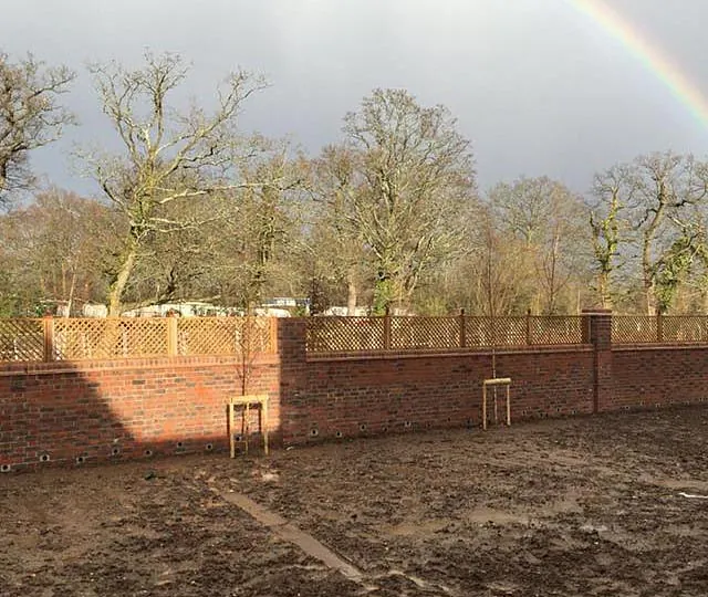 A fence installed above a wall